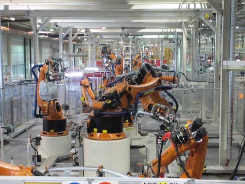 Integrated bodyside welding line with automated industrial robots for car body-in-white (BIW) production.