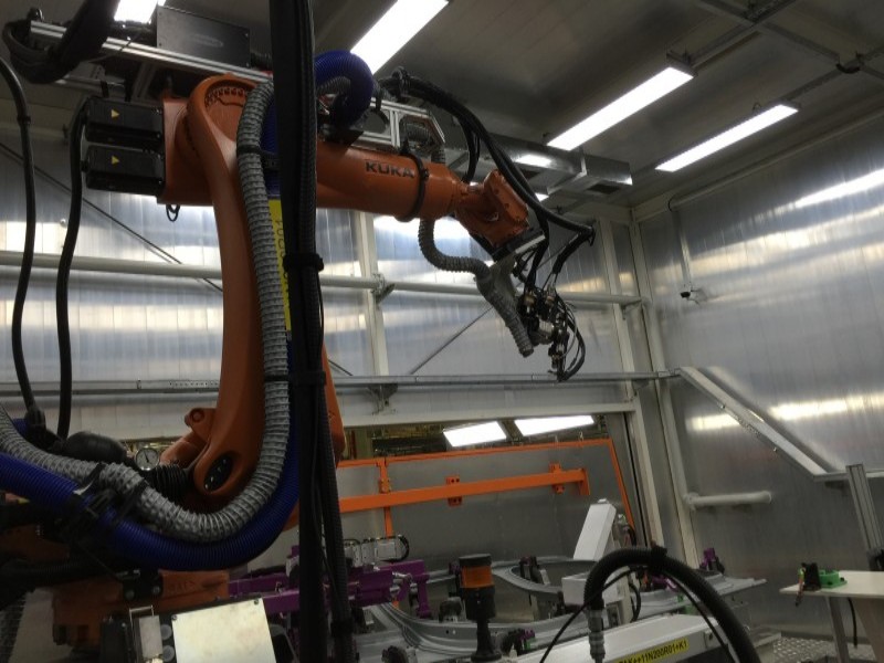 A synchronized multi-robot welding system performing high-precision spot welding on a vehicle chassis.