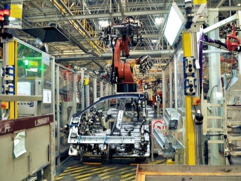robotic automation line for automotive manufacturing with integrated robots and fixtures